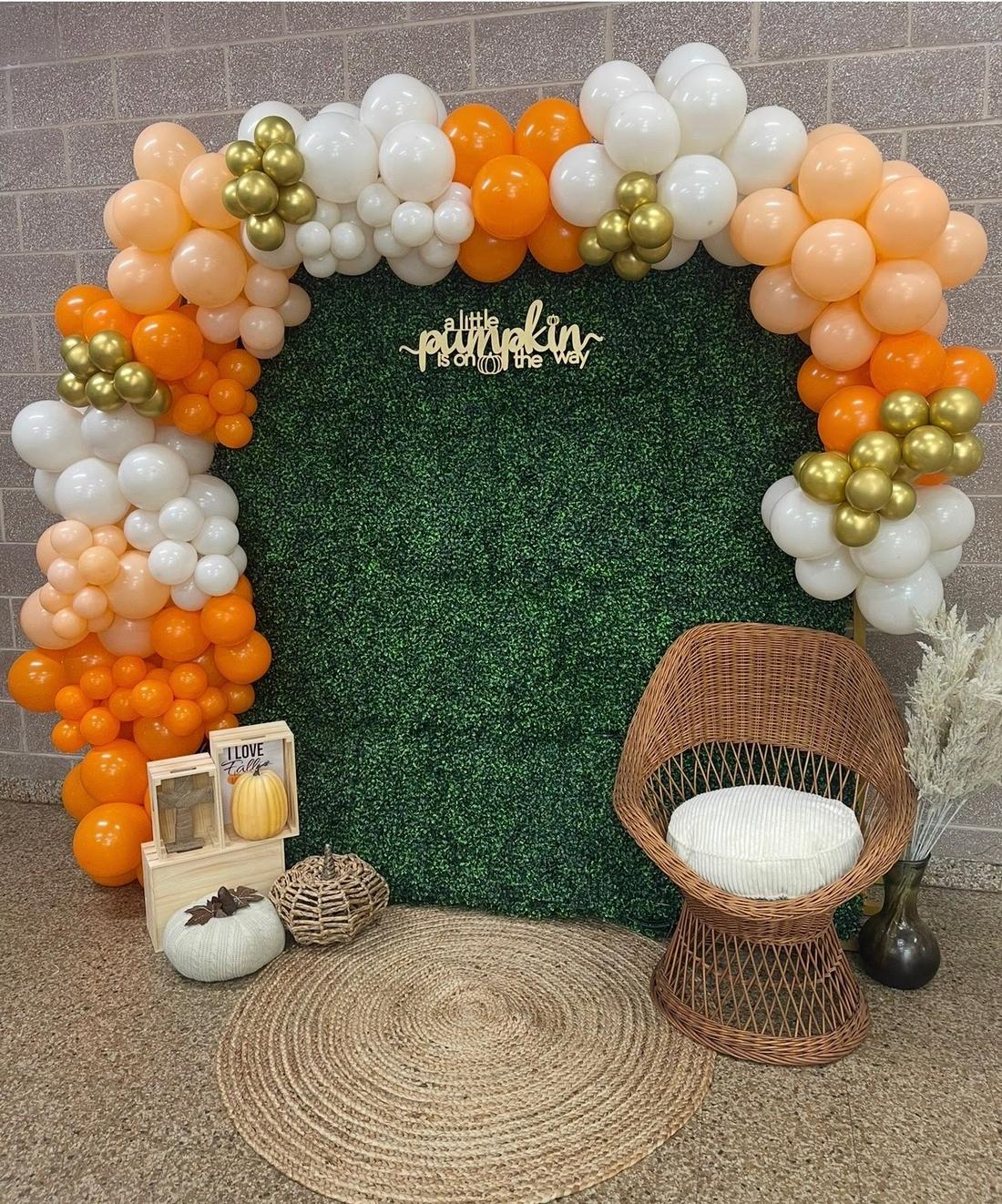 Greenery wall and balloon arch for a fall baby shower