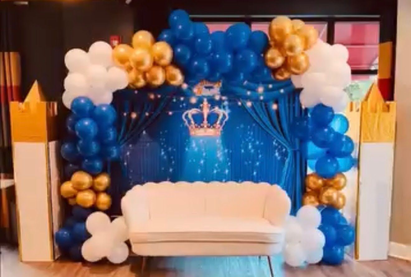 Blue and gold draped backdrop with lounge seating