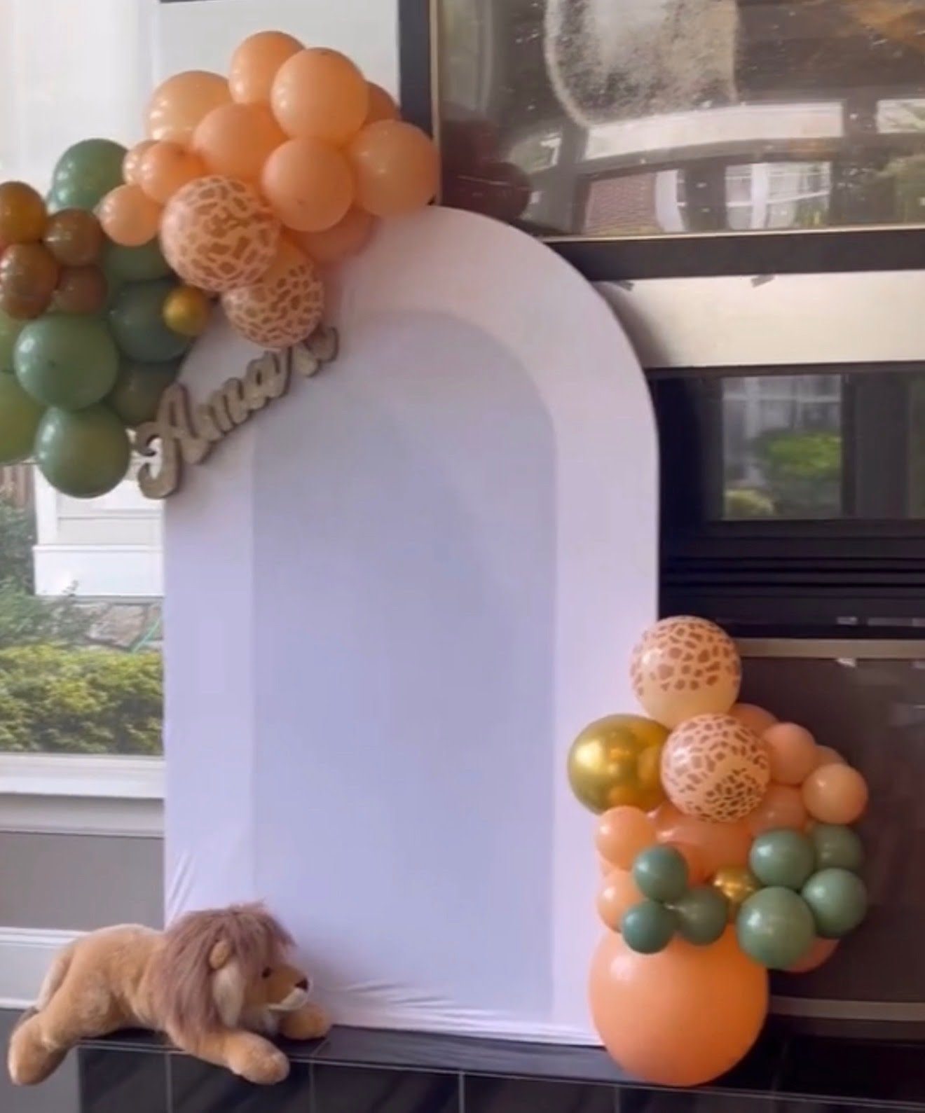 Safari themed arch backdrop with balloon garland