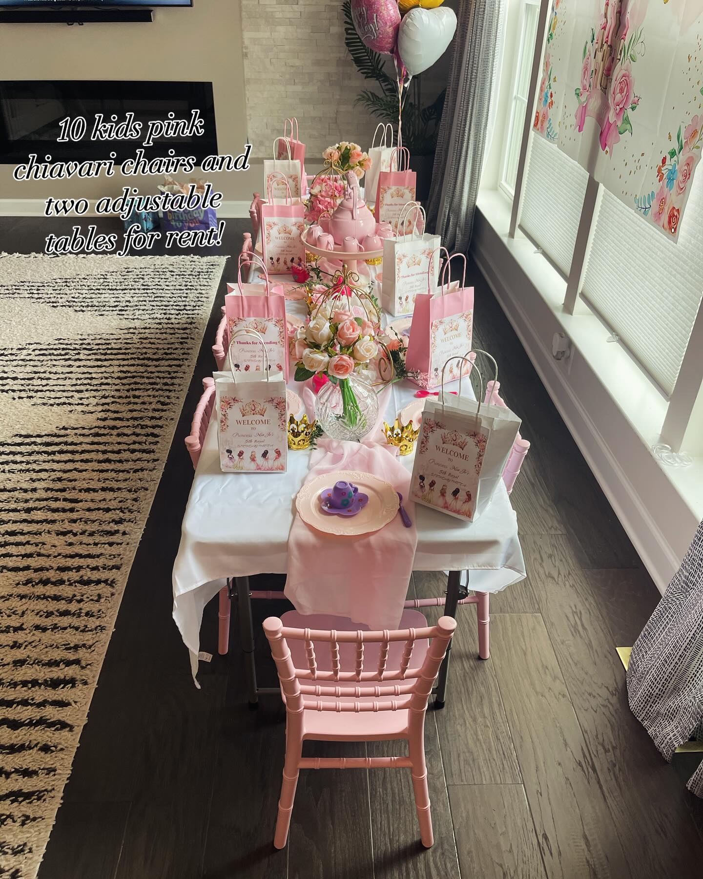 Pink kids tea party table set with a teapot centerpiece, floral arrangements, favor gift bags, tiny crowns and pink chiavari chairs