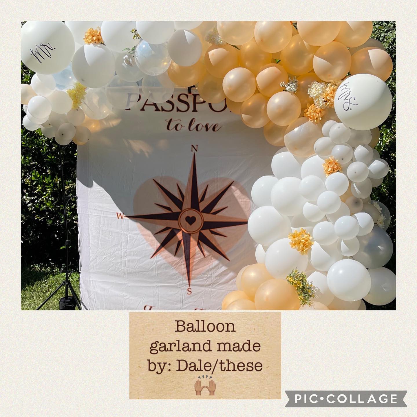 Close-up of a balloon garland arch in white, cream, and peach tones with small floral clusters, in front of a 'Passport to love' backdrop.